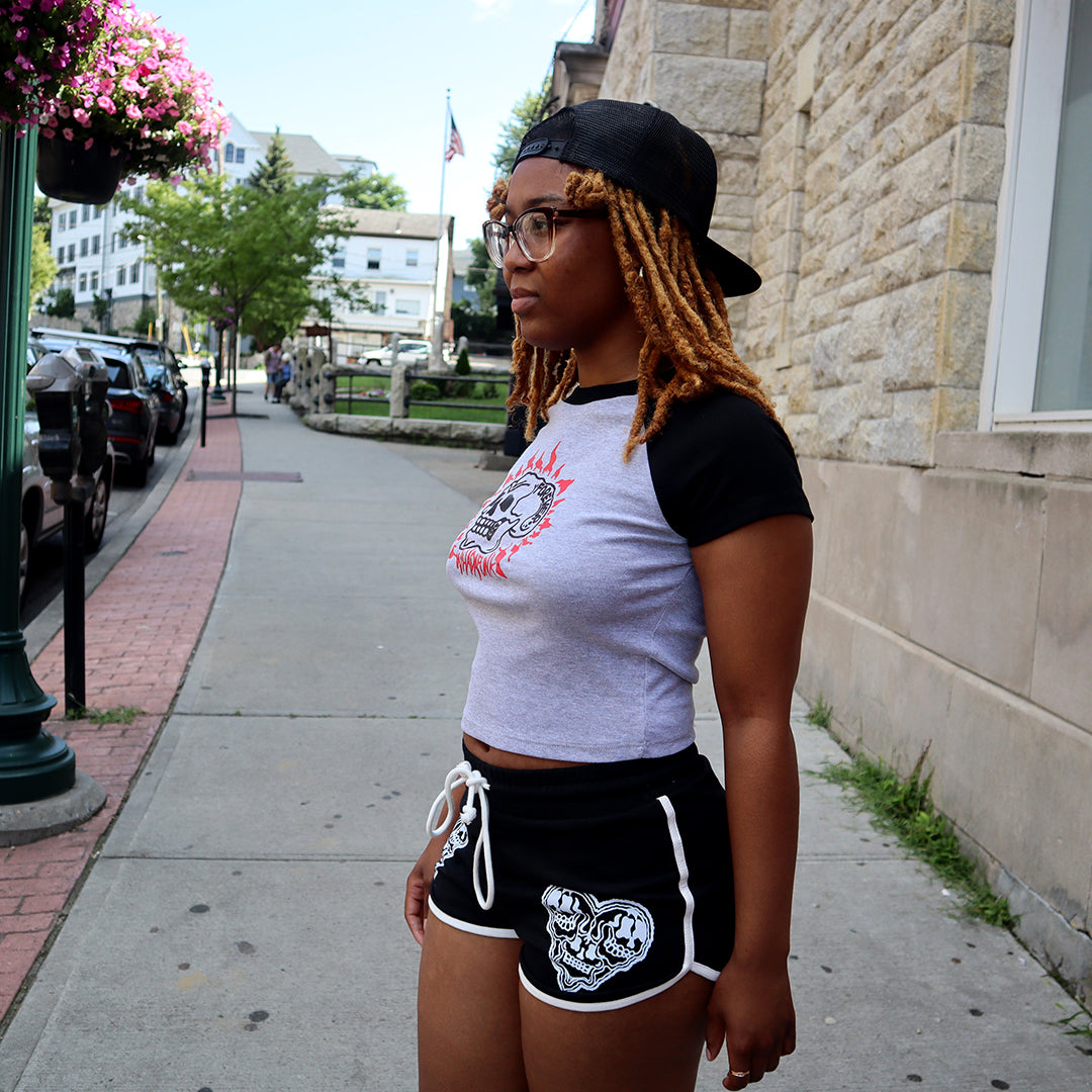 WHADAFUNK Skull Heart Striped Shorts with bold skull and heart graphic design and striped detailing for streetwear style.