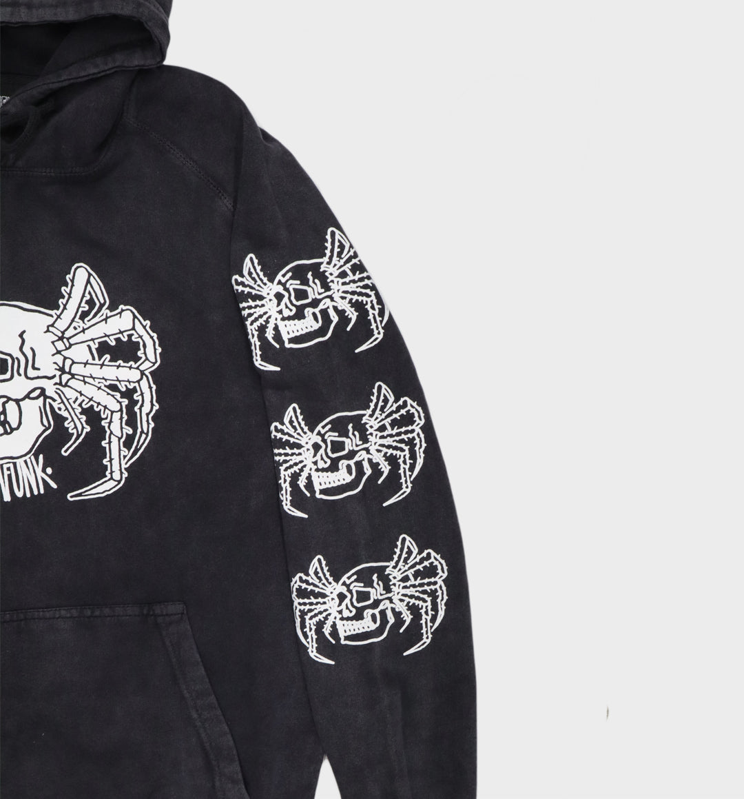 Close-up of hand-drawn spider and skull design on hoodie left sleeve