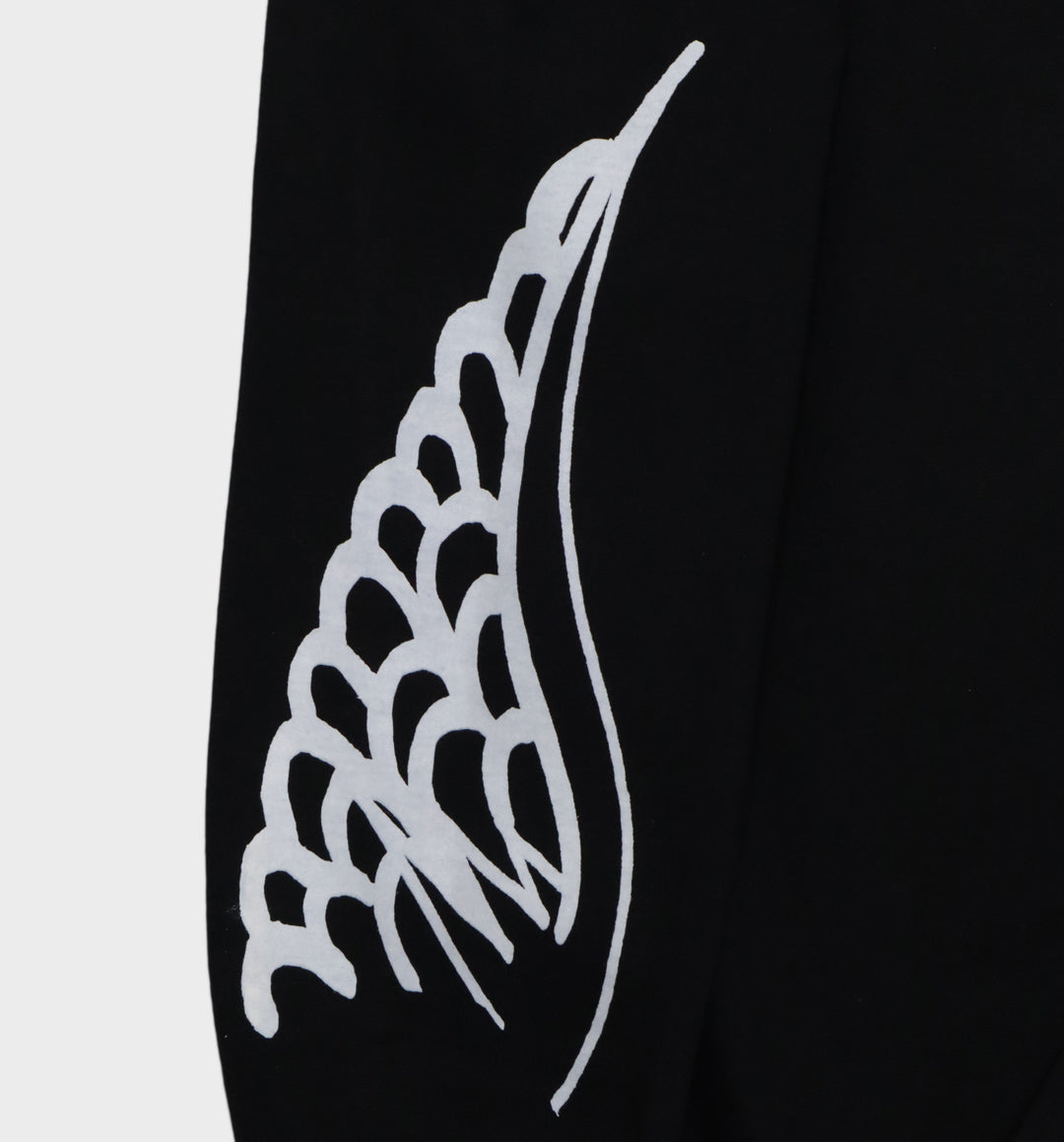 Close up of hand-drawn winged skull and eye design on hoodie