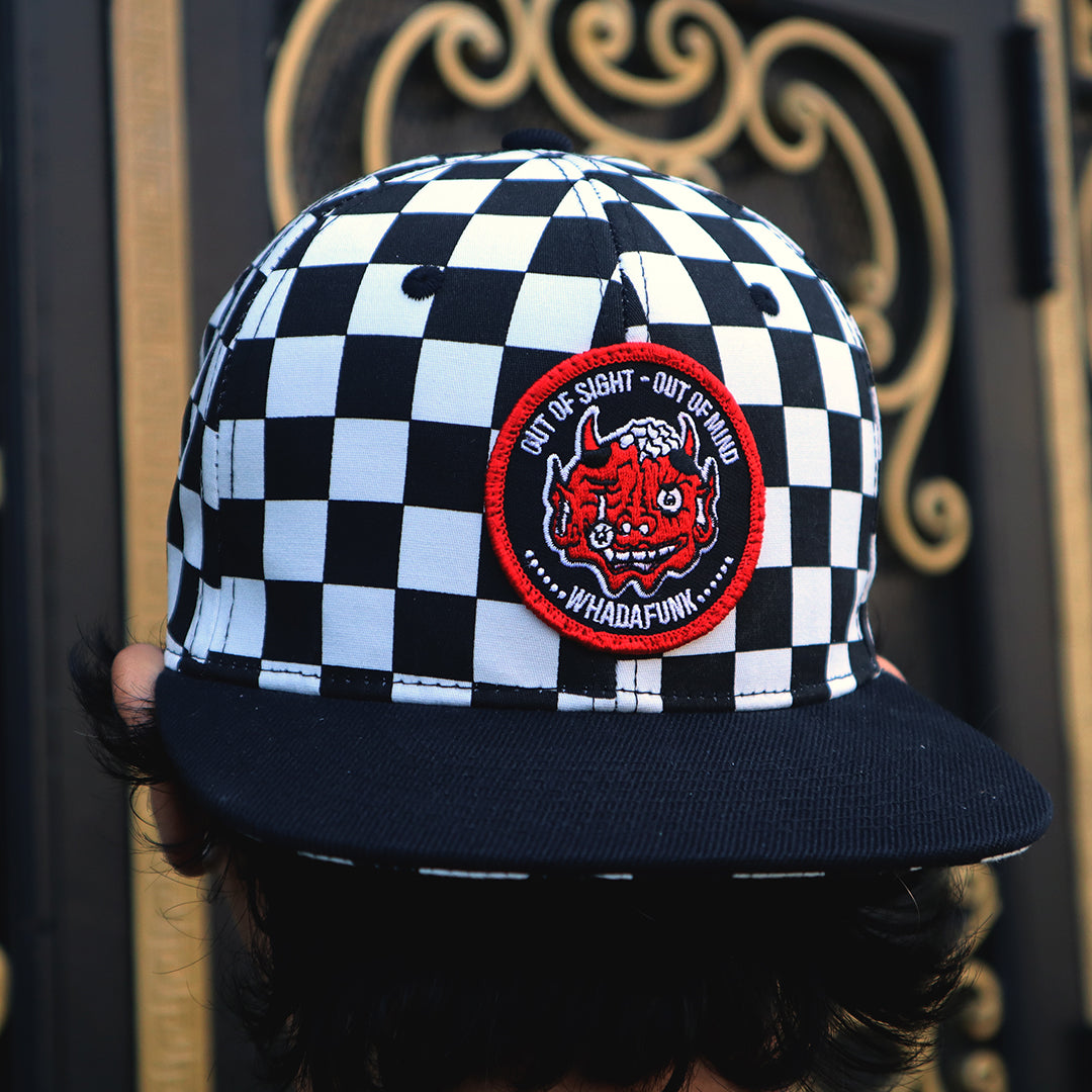 WHADAFUNK Out of Sight Checkered Snapback Hat with bold graphic design for streetwear fans.