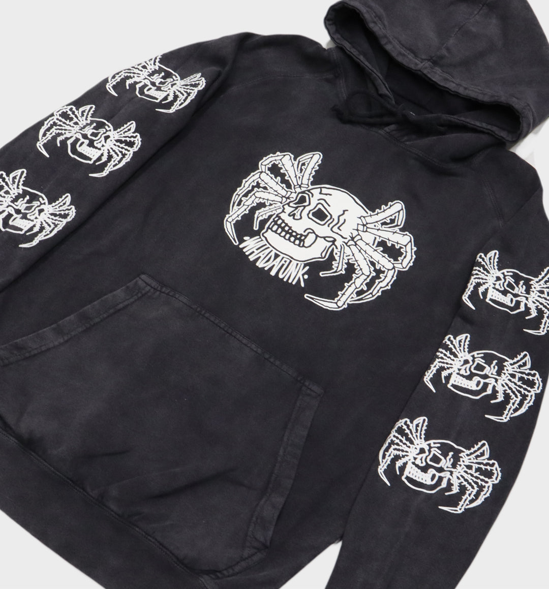 Close-up of hand-drawn spider and skull design on hoodie other angle