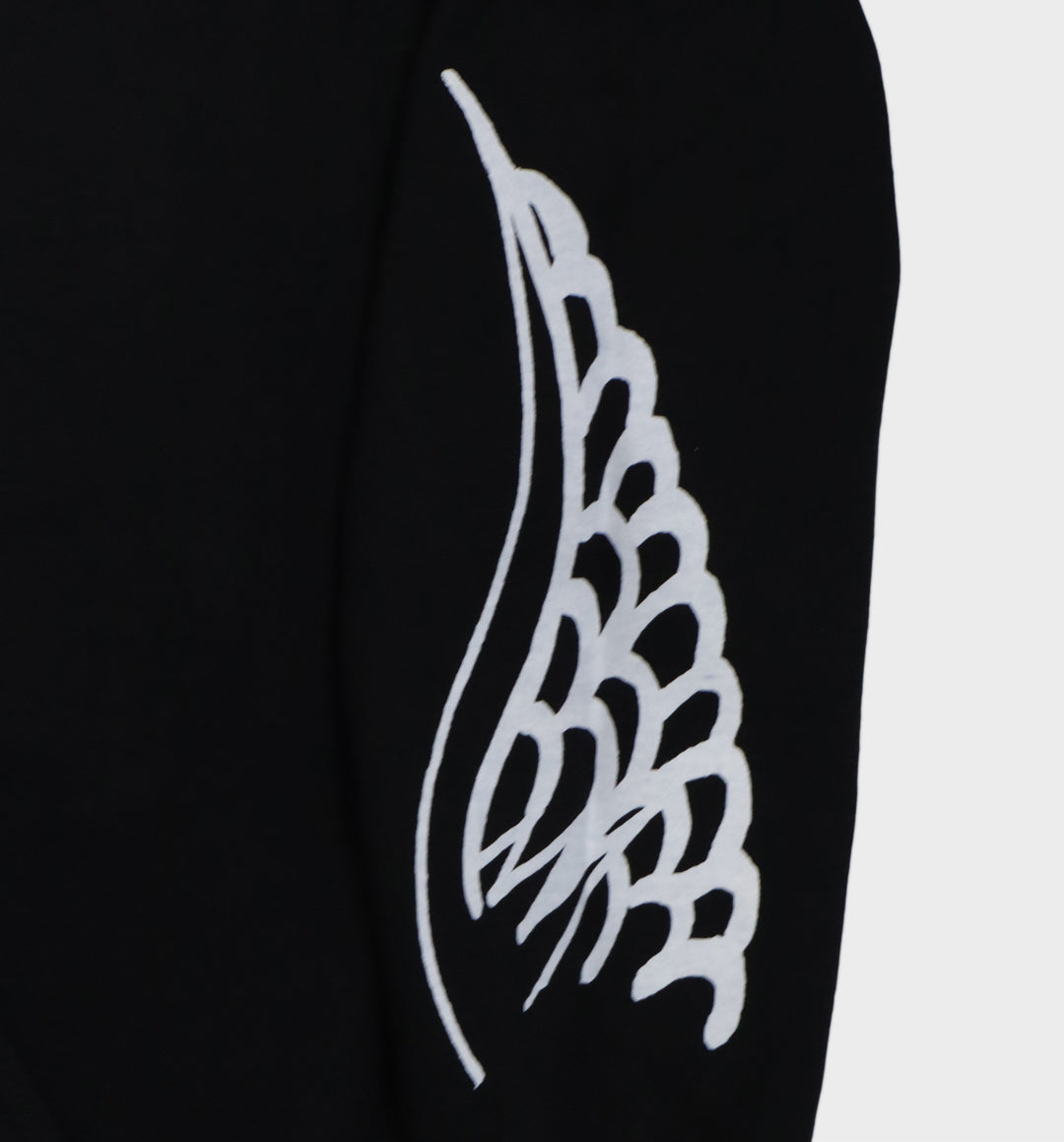 Close up of hand-drawn winged skull and eye design on hoodie