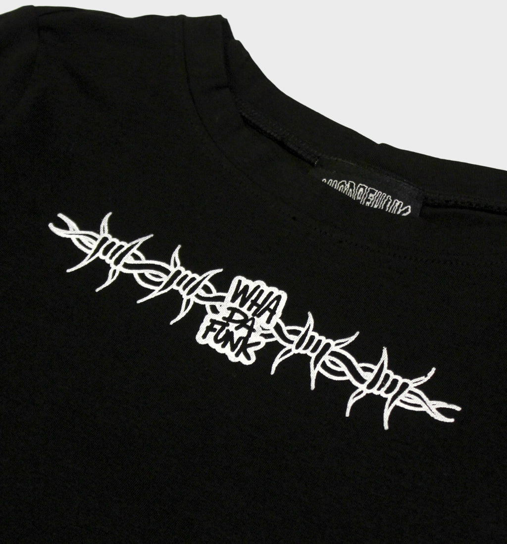 WHADAFUNK Barbed Wire Crop Tee featuring bold barbed wire graphic in streetwear style.